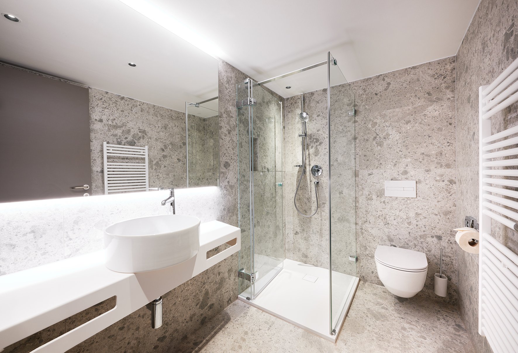 hotel bathroom with washbasin, shower and toilet