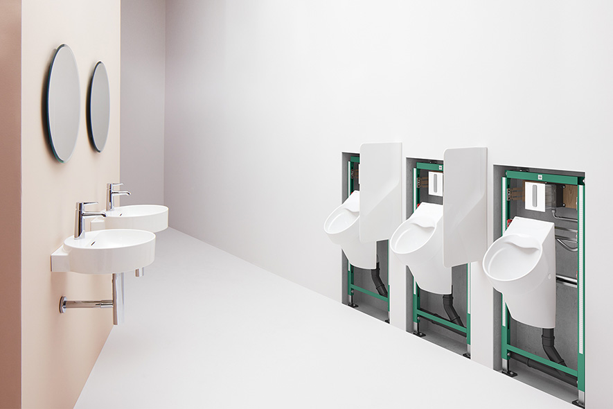 Öffentliches WC mit Urinalen auf sichtbaren Gestelle, zwei runde Waschtische mit Armatur und Spiegel